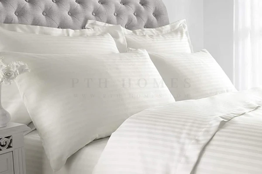 Transform your bedroom into a luxurious retreat with PTH Homes' Cream White Hotel Satin Stripe bedding collection